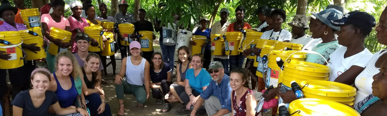 Group of GVSU travelers with local Haitians